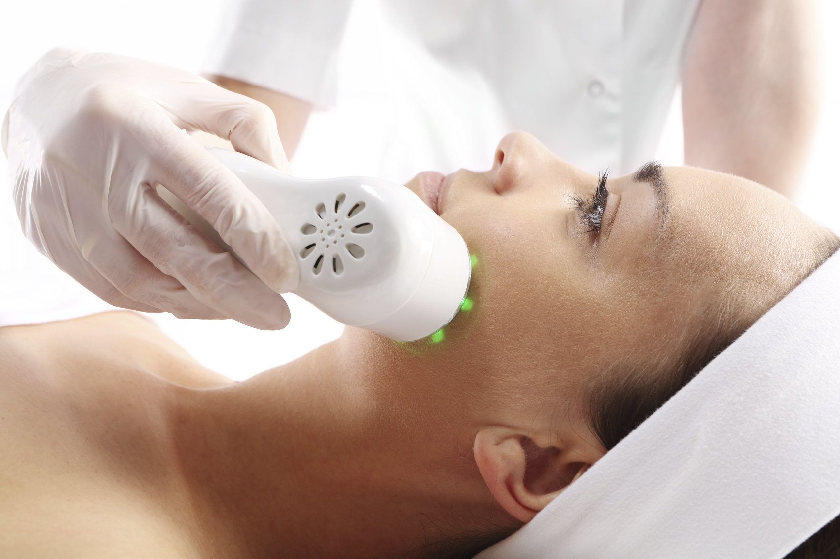 Woman lying down and receiving a microdermabrasion