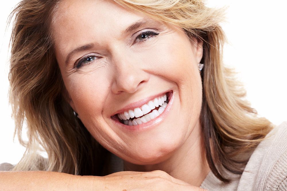 Close up, middle-aged blonde woman smiling after face lift