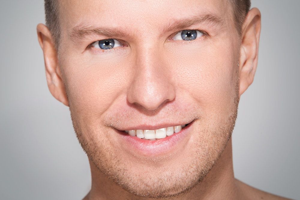 Man's face showing improved nose after rhinoplasty