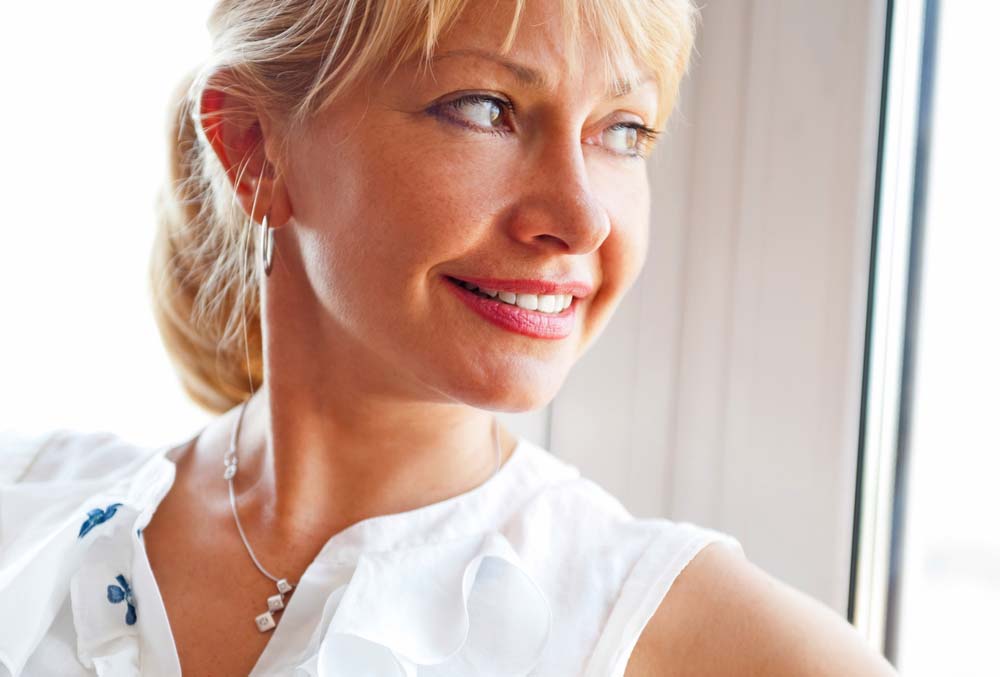 Blonde woman turned away showing smooth neck after neck lift